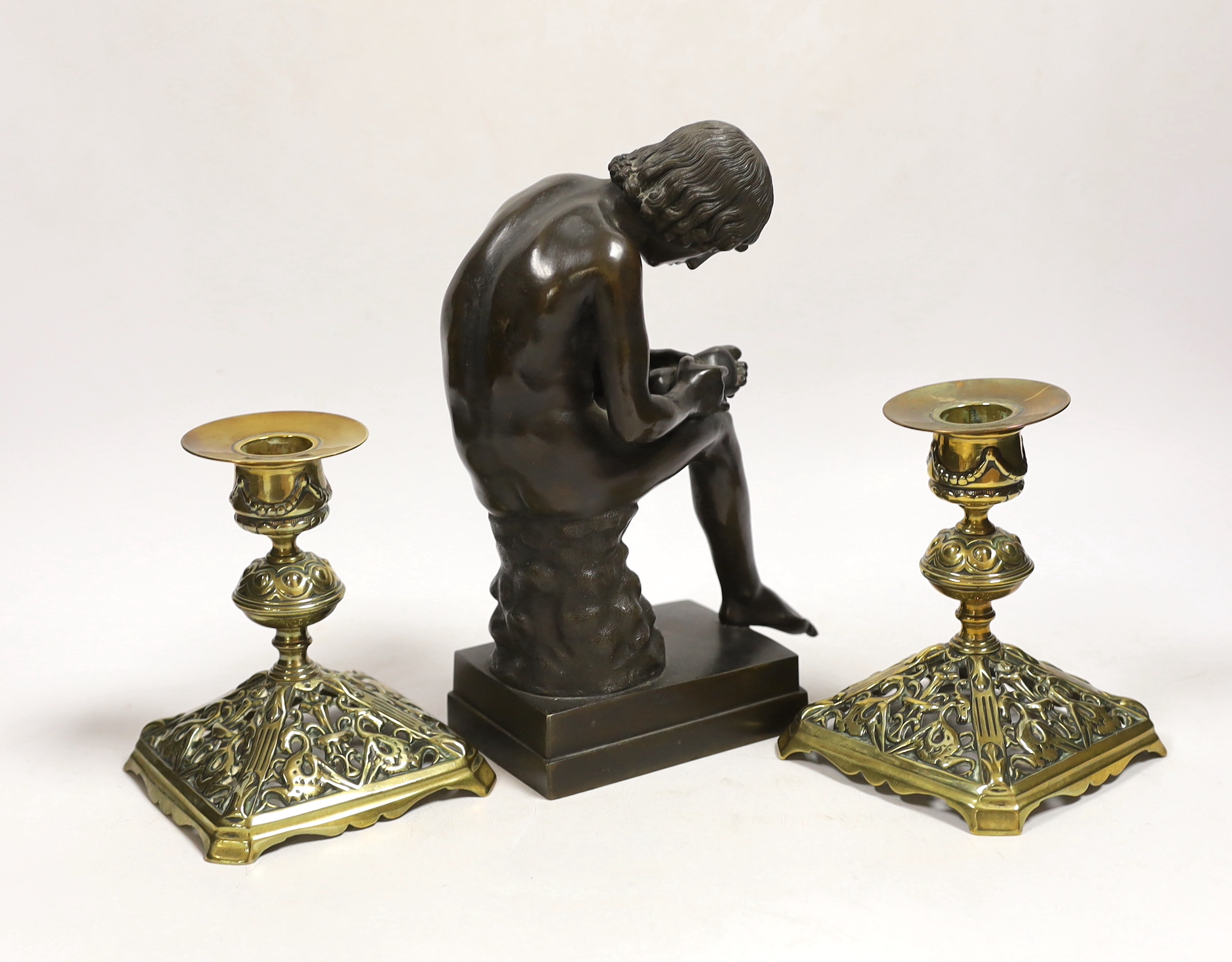 A bronze model of Spinario and a pair of Victorian dwarf candlesticks, lozenge mark to base, tallest 21cm